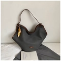 Detail of grey canvas tote bag with brown leather trim and decorative beaded charm - Black with Pendant