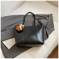 Detailed macro view of black PU leather tote bag with subtle texture and cute bear charm - Black With Pendant