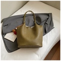 Olive green woven tote bag with colorful pompom charm on a grey blazer background - Green with Pendant
