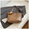 Brown tote bag with vintage texture and teddy bear pendant placed on white linen - Khaki With Pendant