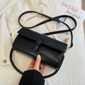 Elegant black faux leather crossbody bag with decorative buckle and adjustable strap - Black