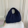 Dettaglio della borsa tote imbottita blu navy con morbida consistenza puffer - Blu scuro