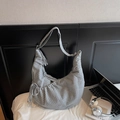 Détail du sac à bandoulière hobo gris à carreaux avec cordons dans un décor lifestyle - Gris