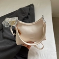 Cream-white leather shoulder bag featuring wooden bead charm and wide strap detail - Rice White Small