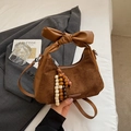 Brown suede crescent bag with leather bow handle and ethnic style wooden bead charm - With Charm / Brown