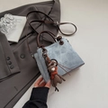 Detail of light blue crossbody bag with brown leather handles and a cute bear charm - With Pendant / Blue