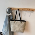 Minimalist marble pattern tote bag in light grey with black straps hanging on a wall hook - Khaki Black