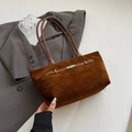 Braune matte Eimertasche mit Silberschnalle und langen Henkeln im schicken Stillleben - Braun