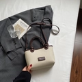 Chic cream canvas bucket bag with brown leather trim and adjustable strap in variant color - No Pendant / Off White