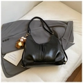 Detail of black faux leather tote bag with a cute brown plush bear charm accessory - Black With Pendant