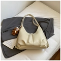 Close-up of beige tote bag texture with brown teddy bear charm and fringe zipper detail - White With Pendant