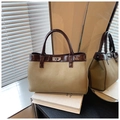 Chic khaki and brown contrast tote bag with silver rotary lock in a lifestyle setting - Khaki (No Pendant)