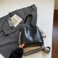 Chic black bucket bag with patterned strap and a white plush charm accessory - Black with Pendant