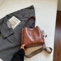 Minimalist brown bucket bag with vintage woven strap and plush ball charm on white background - Brown with Pendant