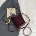 Burgundy quilted suede bucket bag with ethnic beaded tassel charm and slim strap - With Charm / Red