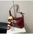 Detail of wine red tote bag with crescent moon shape and cute bear pendant accessory - Red with Pendant
