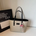 Bolso tote de lona beige de moda con correas de cuero negro y elegante diseño en contraste - Negro (Con Colgante)