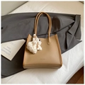 Minimalist camel tote bag in lychee pattern leather with a cute white dog charm - Vertical Brown With Pendant