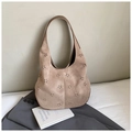 Macro detail of khaki suede hobo bag featuring laser-cut floral hollow patterns - Khaki