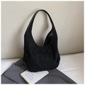 Close-up of black suede hobo bag featuring intricate laser-cut star patterns and texture - Black