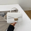 Close-up of white lychee pattern crossbody bag with a golden rectangular buckle - White