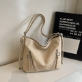 Detail view of beige matte leather shoulder bag featuring star-shaped metal charms - Off White