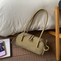 Detail view of olive green cylinder shoulder bag with side bow ties and metal zipper - Elm Green