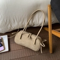 Detail view of khaki suede boston bag with dual shoulder straps and side tie accents - Khaki