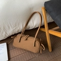 Detail view of khaki matte Boston shoulder bag with zipper and decorative bow straps - Brown
