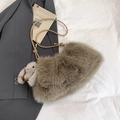 Detailed view of taupe plush bucket bag with leather strap and cute rabbit charm - Coffee With Pendant
