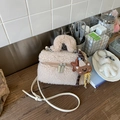 Detail of plush faux fur handbag with cute charms and metal zippers on wood surface - Khaki With Pendant