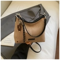 Detail der braunen Retro-Wildledertasche mit Kaffeebohnen-Anhänger und Metall-Logo - Khaki Mit Anhänger