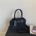 Detail of black suede handbag with metal buckle and branded leather hangtag on handle - Black
