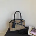 Detail showing brown suede texture and black leather accents on a large shoulder bag - Khaki