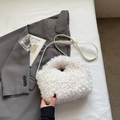 Detail of white plush lamb wool handbag with leather strap and round handle for women - Off-white