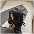 Detail view of retro black crossbody bag with wooden bead pendant and double buckle - Black With Pendant