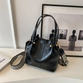 Vintage Eimertasche aus schwarzem Leder mit Retro-Mustergurt und goldenen Details - Schwarz