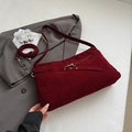 Detail of burgundy suede tote bag featuring fine leather strap and metal buckle fastener - Red