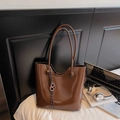 Brown high-gloss patent leather tote bag with shoulder straps and modern urban design - With Charm / Brown