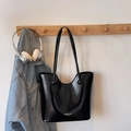 Minimalist black glossy leather tote bag with brand lettering hanging on a wall hook - No Pendant / Black