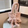 Detailed macro view of pink and grey leopard print plush faux fur tote with long decorative ribbons - Pink Leopard