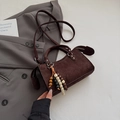 Detail of dark brown suede crossbody bag featuring ethnic beads and long zipper pulls - Coffee With Pendant