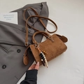 Close-up of vintage brown suede crossbody bag with metal rivets and wooden bead charm - Brown with Pendant
