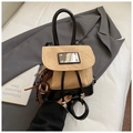 Detail of khaki canvas and black leather backpack with a decorative donut charm - Khaki With Pendant