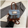 Detail of vintage denim backpack showing leather trim, drawstring, and metal hardware - Blue with Pendant