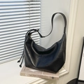 Close-up of black leather tote bag showing soft texture and drawstring knot detail - Black without Pendant