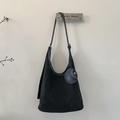 Detail of minimalist black suede hobo bag with adjustable strap and round coin pouch - Black