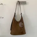 Detail of vintage matte suede shoulder bucket bag with matching small round pouch - Brown
