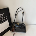 Dettaglio della borsa tote nera lucida con scritte logo dorate e doppia chiusura a zip - Nero (Con Ciondolo)