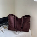 Vintage dark purple suede tote bag with gold buckle detail in a cozy home office setting - Brown